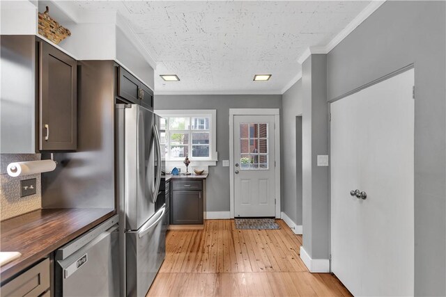111 E Sheridan Ave, New Castle/2Nd, PA 16105 - kitchen with appliances with stainless steel finishes, light wood-type flooring, crown molding, baseboards, and butcher block counters