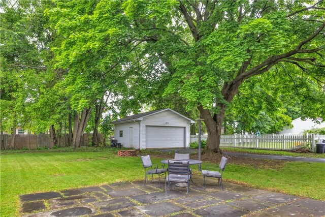 111 E Sheridan Ave, New Castle/2Nd, PA 16105 - view of patio / terrace featuring an outdoor structure, a garage, and outdoor dining area
