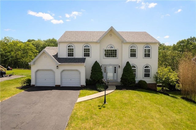 821 Kingston Dr, South Fayette, PA 15057 - colonial-style house featuring asphalt driveway, a front yard, and a shingled roof