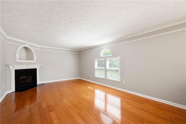 821 Kingston Dr, South Fayette, PA 15057 - unfurnished living room featuring a textured ceiling, light wood-type flooring, a fireplace with flush hearth, baseboards, and ornamental molding