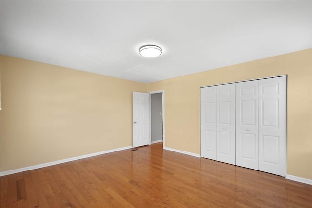 821 Kingston Dr, South Fayette, PA 15057 - unfurnished bedroom with wood finished floors, baseboards, and a closet