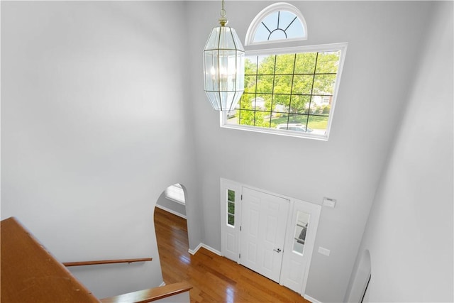 821 Kingston Dr, South Fayette, PA 15057 - entryway featuring wood finished floors, a high ceiling, arched walkways, and baseboards