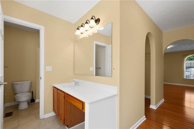 821 Kingston Dr, South Fayette, PA 15057 - bathroom with vanity, toilet, baseboards, and wood finished floors