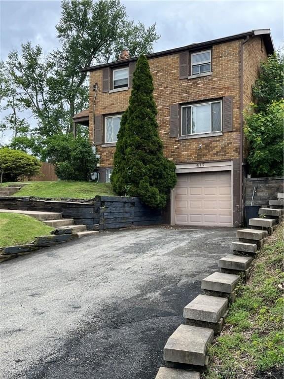 417 Longview Dr, Monroeville, PA 15146 - view of front of property with an attached garage, brick siding, and asphalt driveway