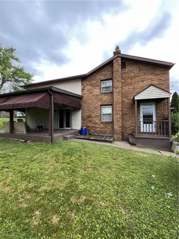 417 Longview Dr, Monroeville, PA 15146 - rear view of property with brick siding, a chimney, a lawn, and a patio