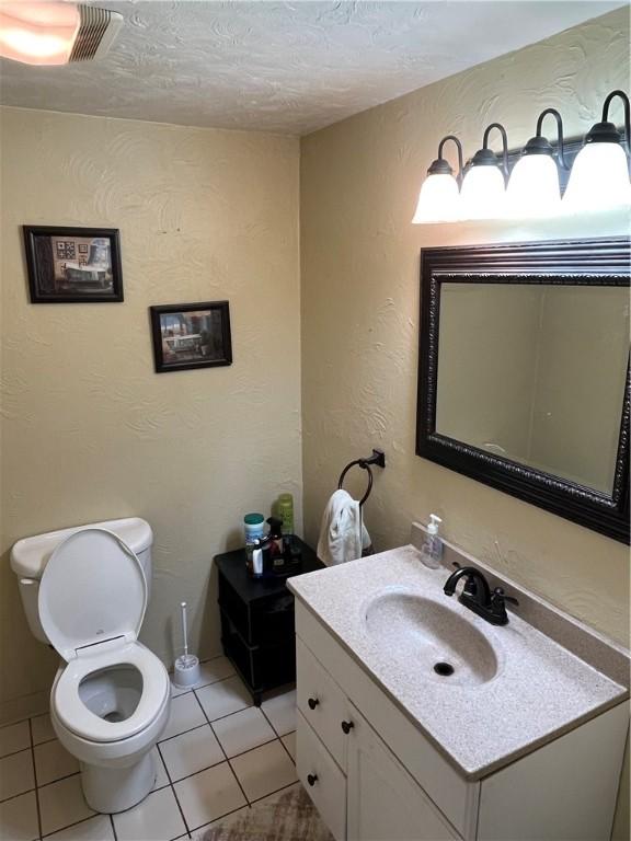 417 Longview Dr, Monroeville, PA 15146 - half bathroom with toilet, vanity, tile patterned floors, and a textured ceiling