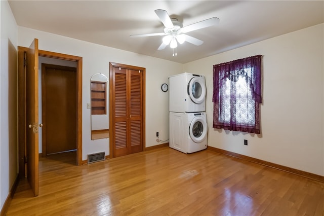 1007 High St, Luzerne Twp, PA 15417 - laundry room featuring stacked washing machine and dryer, light wood-type flooring, a ceiling fan, and baseboards