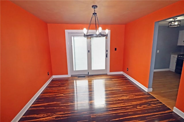 418 Newport Dr, Hempfield Twp Wml, PA 15601 - unfurnished dining area featuring a chandelier, wood finished floors, and baseboards
