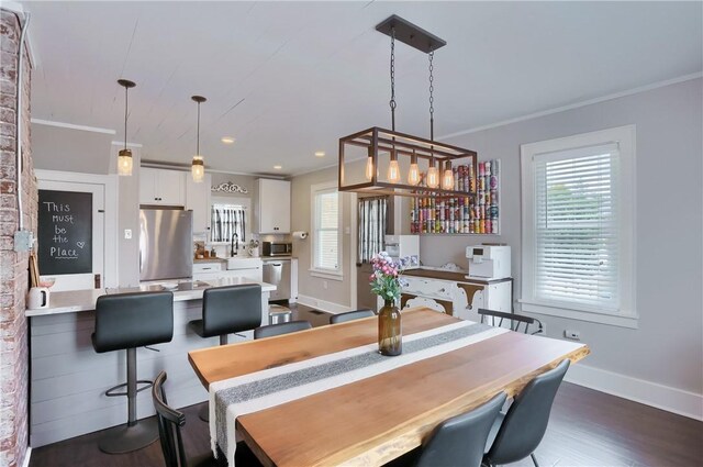 27 Laurel Ave, City Of Washington, PA 15301 - dining space with healthy amount of natural light, crown molding, baseboards, and dark wood-style flooring