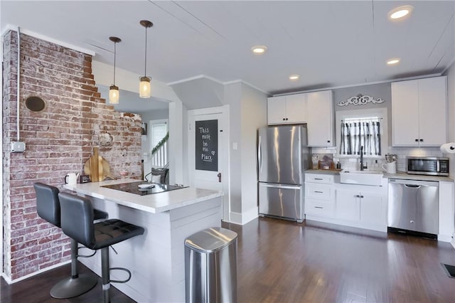 27 Laurel Ave, City Of Washington, PA 15301 - kitchen featuring appliances with stainless steel finishes, a sink, dark wood-style floors, light countertops, and pendant lighting