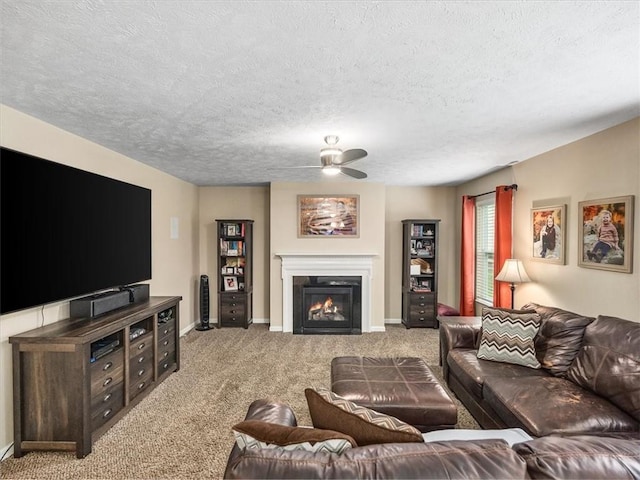 8045 Maureen Dr, Cranberry Twp, PA 16066 - carpeted living room with ceiling fan, a textured ceiling, a lit fireplace, and baseboards