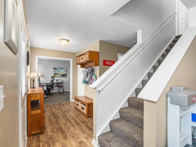 8045 Maureen Dr, Cranberry Twp, PA 16066 - stairs with wood finished floors and a textured ceiling