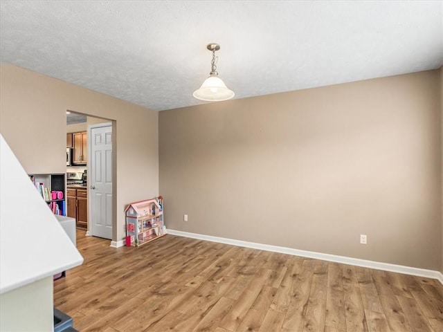 8045 Maureen Dr, Cranberry Twp, PA 16066 - unfurnished dining area featuring baseboards and light wood-style flooring