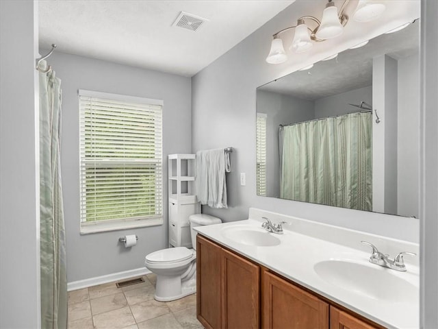 8045 Maureen Dr, Cranberry Twp, PA 16066 - bathroom featuring healthy amount of natural light, toilet, double vanity, and baseboards