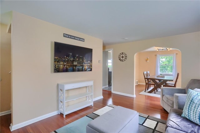 2114 Swallow Hill Rd, Scott Twp Sal, PA 15220 - living room with arched walkways, wood finished floors, baseboards, and a chandelier