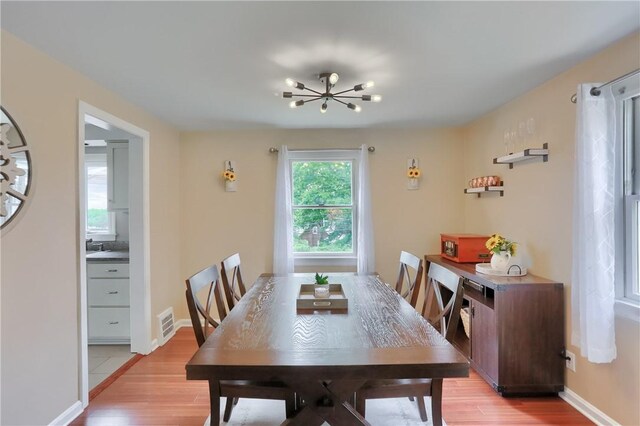 2114 Swallow Hill Rd, Scott Twp Sal, PA 15220 - dining room with light wood-style floors, a chandelier, and baseboards