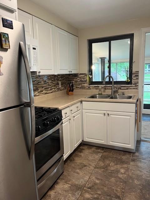 102 Rose Ave, Ross Twp, PA 15229 - kitchen with appliances with stainless steel finishes, a sink, backsplash, white cabinets, and light countertops