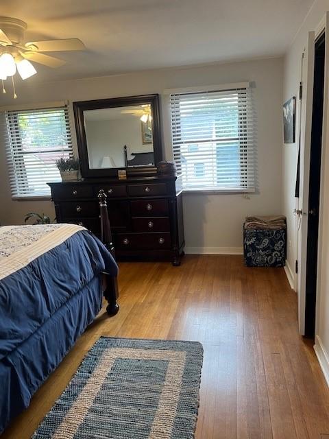 102 Rose Ave, Ross Twp, PA 15229 - bedroom with light wood finished floors, multiple windows, baseboards, and ceiling fan