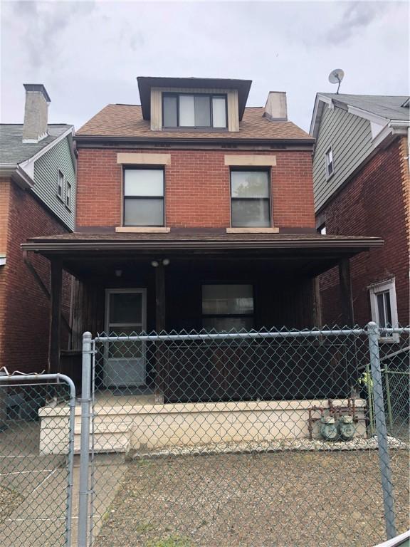 229 Moore Ave, Knoxville, PA 15210 - view of front facade featuring brick siding and covered porch