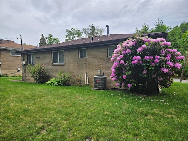 116 Bellwood Rd, West Mifflin, PA 15122 - back of house featuring central AC unit, a yard, and brick siding