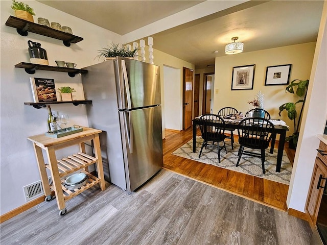 116 Bellwood Rd, West Mifflin, PA 15122 - kitchen with freestanding refrigerator, wood finished floors, baseboards, and open shelves
