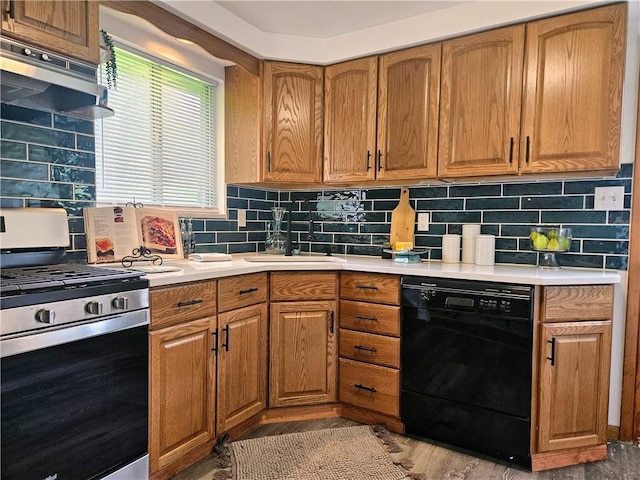 116 Bellwood Rd, West Mifflin, PA 15122 - kitchen featuring stainless steel gas stove, black dishwasher, a sink, tasteful backsplash, and light countertops