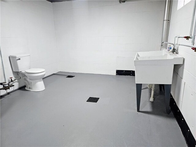 116 Bellwood Rd, West Mifflin, PA 15122 - bathroom with toilet, concrete flooring, and concrete block wall