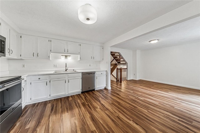 2708 Bingham Dr, Upper St Clair, PA 15241 - kitchen with appliances with stainless steel finishes, a sink, dark wood finished floors, white cabinetry, and a textured ceiling