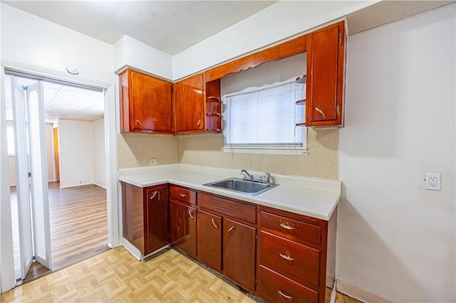 619 1st St, Verona, PA 15147 - kitchen featuring a sink, light countertops, parquet floors, and tasteful backsplash