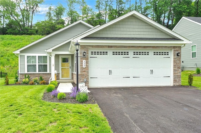 339 Nelson Dr, Monroeville, PA 15146 - craftsman house featuring stone siding, a front yard, asphalt driveway, and a garage