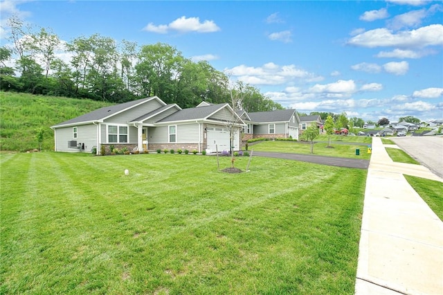 339 Nelson Dr, Monroeville, PA 15146 - view of front of house with an attached garage, a front yard, asphalt driveway, a residential view, and stone siding