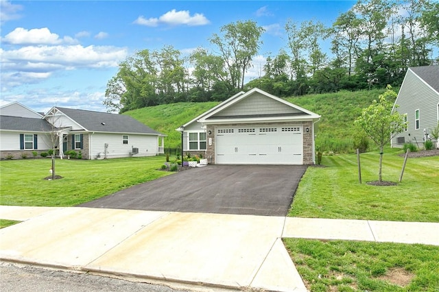 339 Nelson Dr, Monroeville, PA 15146 - view of front of house with a detached garage, a front lawn, and stone siding