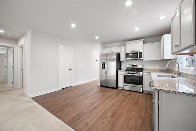 339 Nelson Dr, Monroeville, PA 15146 - kitchen with appliances with stainless steel finishes, a sink, recessed lighting, light stone counters, and baseboards
