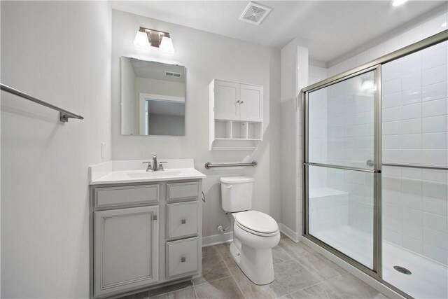 339 Nelson Dr, Monroeville, PA 15146 - full bath featuring toilet, a stall shower, vanity, baseboards, and tile patterned floors