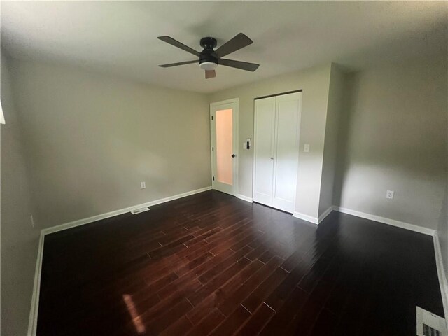 1601 Burchfield Rd, Shaler, PA 15101 - unfurnished bedroom featuring dark wood-style flooring, baseboards, a ceiling fan, and a closet