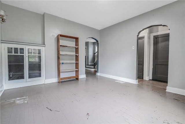 122 Margaret St, Mount Oliver, PA 15210 - unfurnished room with arched walkways, baseboards, and wood finished floors