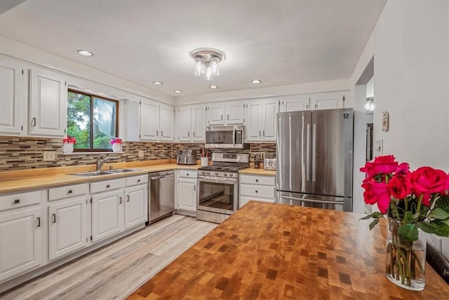 1382 Great Oak Dr, Scott Twp Sal, PA 15220 - kitchen with appliances with stainless steel finishes, a sink, butcher block counters, white cabinets, and decorative backsplash