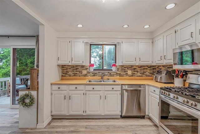 1382 Great Oak Dr, Scott Twp Sal, PA 15220 - kitchen with appliances with stainless steel finishes, a sink, white cabinetry, light countertops, and healthy amount of natural light