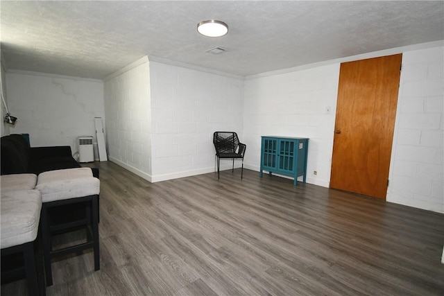 341 Macassar Dr, Baldwin Boro, PA 15236 - sitting room with a textured ceiling, concrete block wall, and wood finished floors