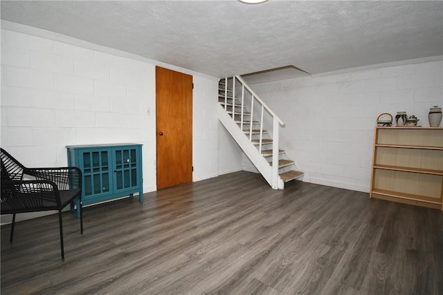 341 Macassar Dr, Baldwin Boro, PA 15236 - basement featuring wood finished floors, concrete block wall, stairs, and a textured ceiling