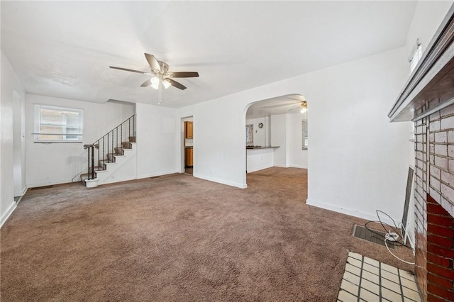 1124 Ridgeland Dr, Marshall Shadeland, PA 15212 - unfurnished living room with a ceiling fan, a fireplace, carpet, and stairs