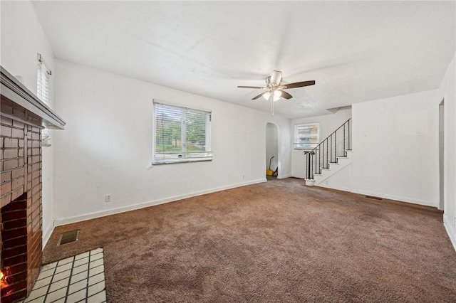 1124 Ridgeland Dr, Marshall Shadeland, PA 15212 - unfurnished living room featuring a brick fireplace, arched walkways, stairs, a ceiling fan, and carpet floors