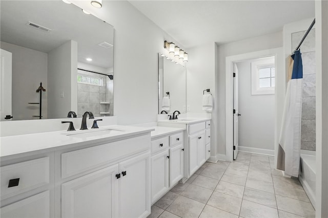 5023 Kensington Dr, Cecil, PA 15317 - bathroom with double vanity, plenty of natural light, shower / bath combo with shower curtain, and baseboards