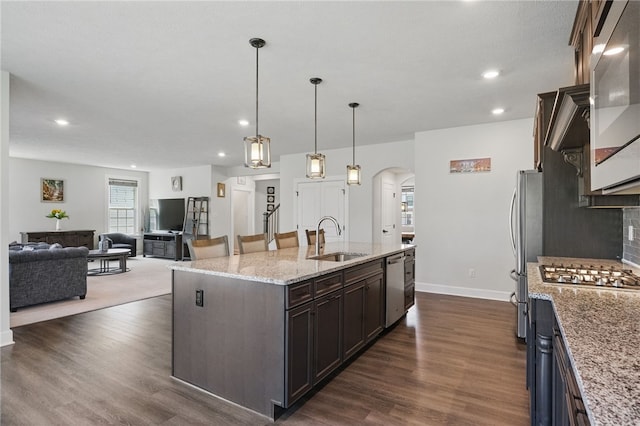 5023 Kensington Dr, Cecil, PA 15317 - kitchen with a sink, arched walkways, stainless steel appliances, baseboards, and dark wood-style floors