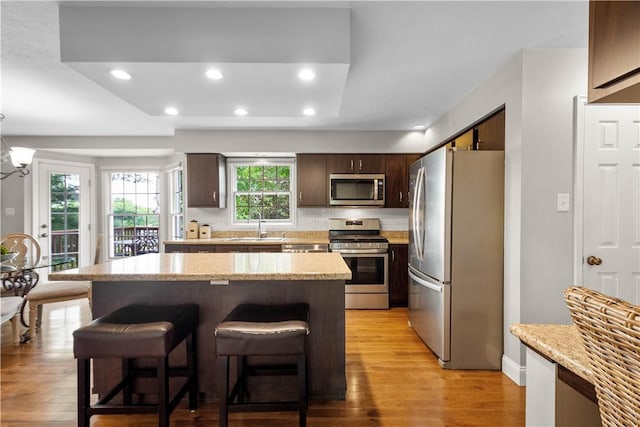 401 Pebble Creek Dr, Cranberry Twp, PA 16066 - kitchen featuring stainless steel appliances, a sink, a kitchen breakfast bar, light wood-style flooring, and recessed lighting