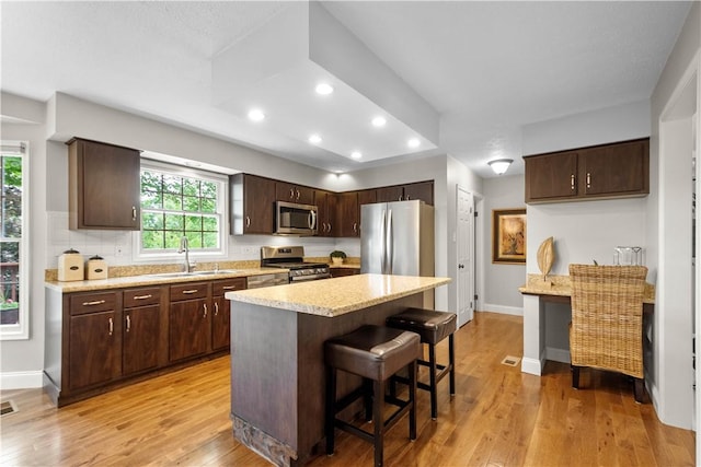 401 Pebble Creek Dr, Cranberry Twp, PA 16066 - kitchen with a sink, stainless steel appliances, recessed lighting, dark brown cabinets, and light wood-style flooring