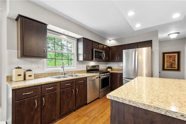 401 Pebble Creek Dr, Cranberry Twp, PA 16066 - kitchen with stainless steel appliances, a sink, light wood-style flooring, light countertops, and dark brown cabinetry