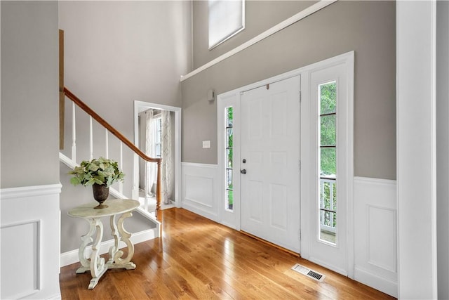 401 Pebble Creek Dr, Cranberry Twp, PA 16066 - foyer entrance with hardwood / wood-style floors, stairway, wainscoting, a decorative wall, and a towering ceiling