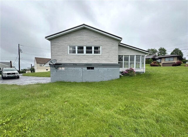 1100 Tener St, Richland School District, PA 15904 - rear view of house featuring a sunroom, a lawn, and concrete driveway