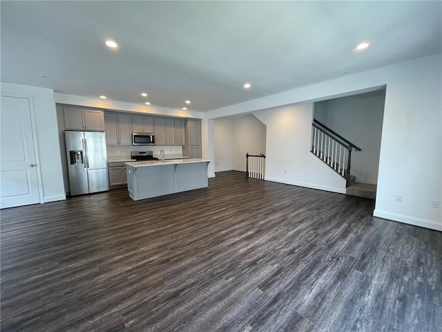 2122 Westcott Ln, South Fayette, PA 15017 - kitchen featuring appliances with stainless steel finishes, gray cabinets, open floor plan, light countertops, and baseboards